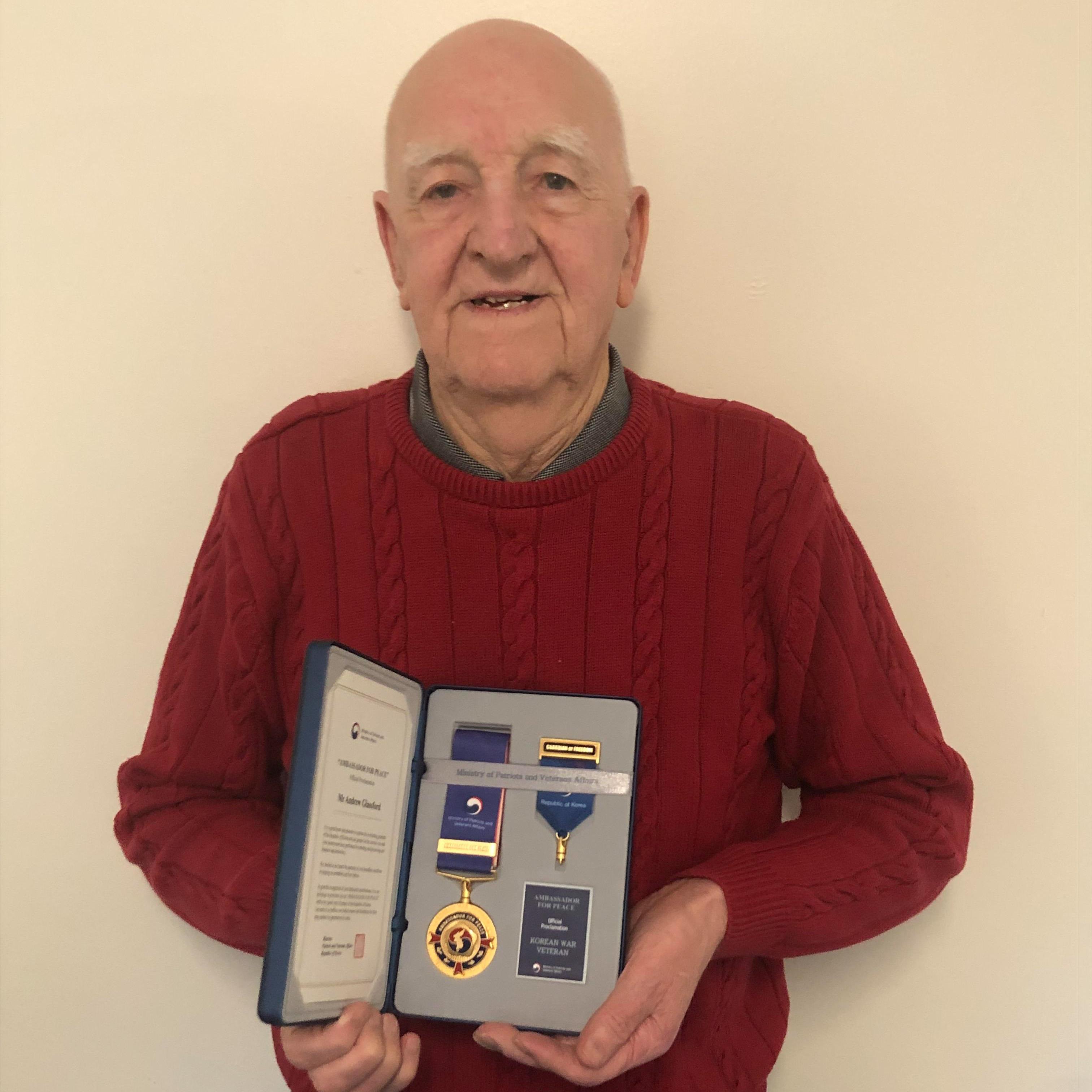 Andrew Glassford with his Ambassador for Peace medal